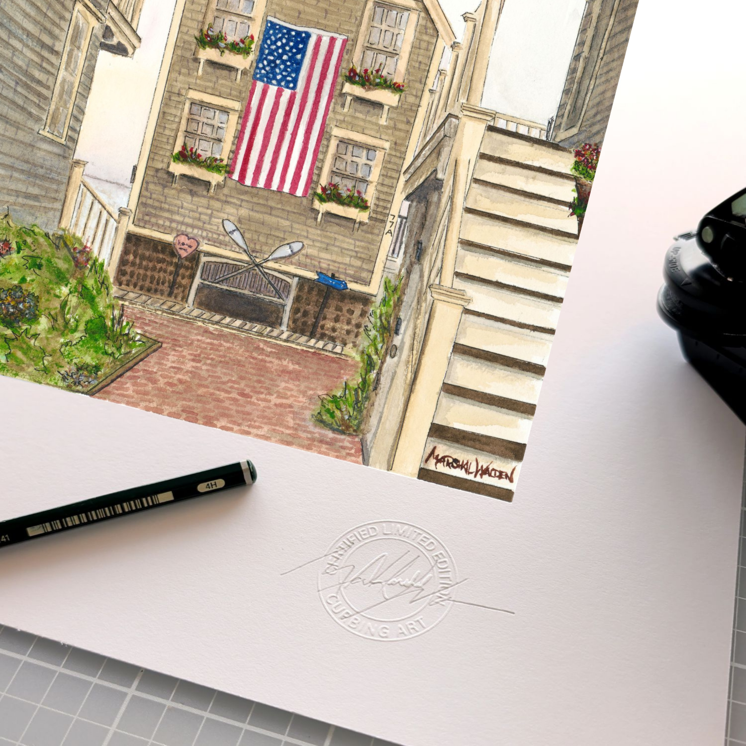 A close-up photograph showing limited edition art print "77A Commercial." with raised circular "Curbing Art" studio embossing. Resting beside the seal are the artist's graphite pencil used for signing and numbering, and the metal hand-embossing tool.