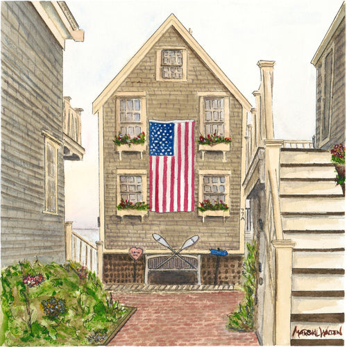 A high-resolution close-up photograph showcasing the intricate details and fine art paper texture of the limited edition print "77A Commercial" by artist Marshal Walden. The image highlights the weathered shingles of the historic Cape Cod home, a large American flag, crossed oars, and flower-filled window boxes.
