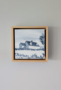 Front view of Presence, a minimalist monochrome watercolor study of a coastal home, isolated within a deep natural maple float mount frame on a neutral wall.