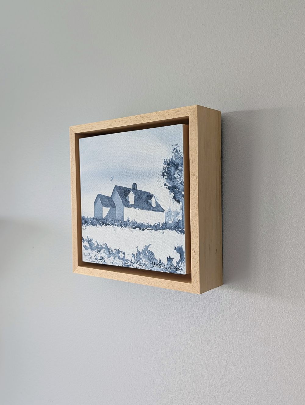 Right side view of Presence, a minimalist monochrome watercolor study of a coastal home, isolated within a deep natural maple float mount frame on a neutral wall.