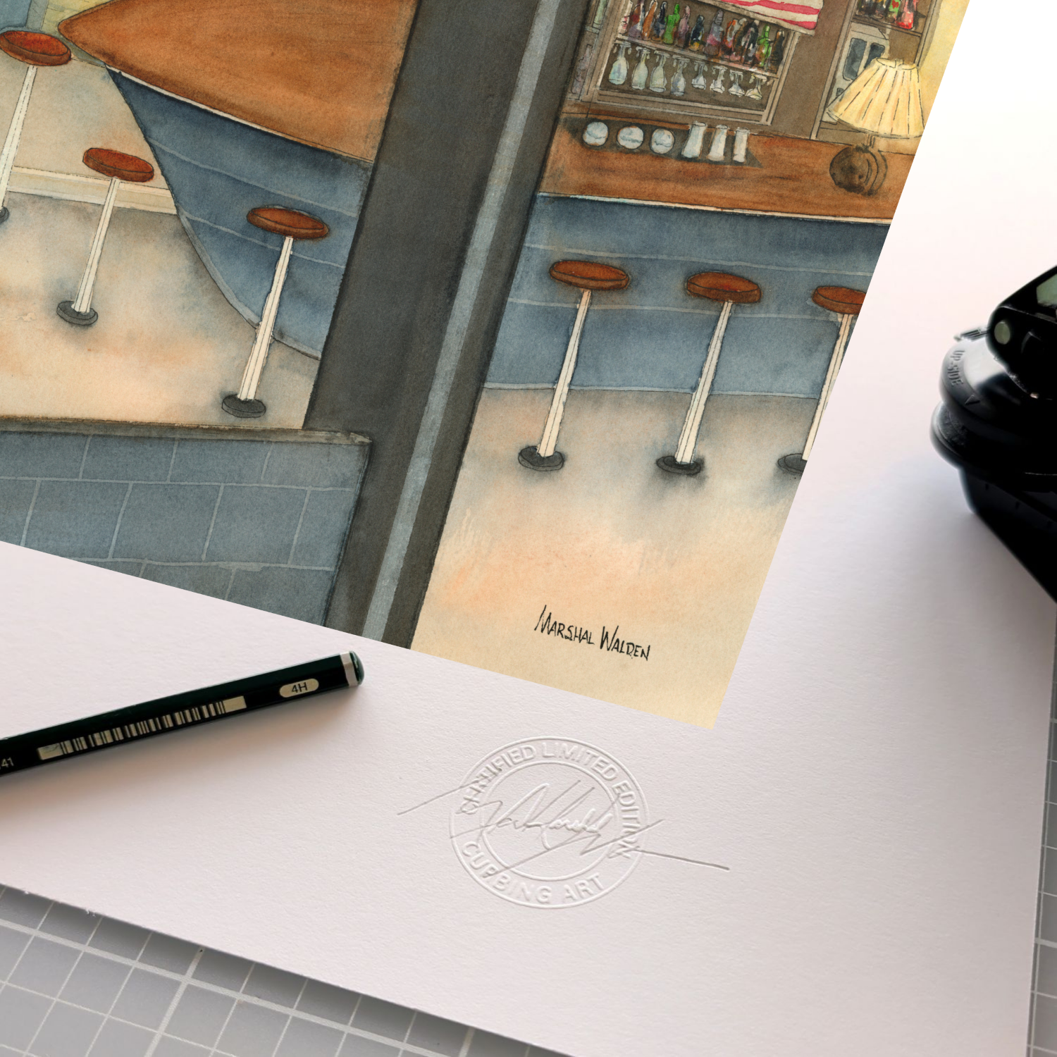 A detailed close-up photograph showing the authentication elements on the wide white border of the limited edition fine art print "Anybody's Bar." The focus is on the official, raised circular "Curbing Art" studio embossing seal pressed into the surface of the textured fine art paper. Resting beside the seal are the artist's graphite pencil used for signing and numbering, and the metal hand-embossing tool used to create the seal.
