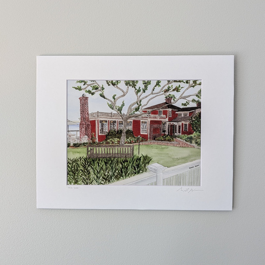 A professionally matted fine art watercolor print titled "The Red Inn", titled and signed by PAAM artist Marshal Walden on the matting. The artwork captures the iconic red landmark in Provincetown, focusing on its structural bones and architectural beauty, displayed centered against a neutral beige wall.
