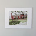 A professionally matted fine art watercolor print titled "The Red Inn", titled and signed by PAAM artist Marshal Walden on the matting. The artwork captures the iconic red landmark in Provincetown, focusing on its structural bones and architectural beauty, displayed centered against a neutral beige wall.
