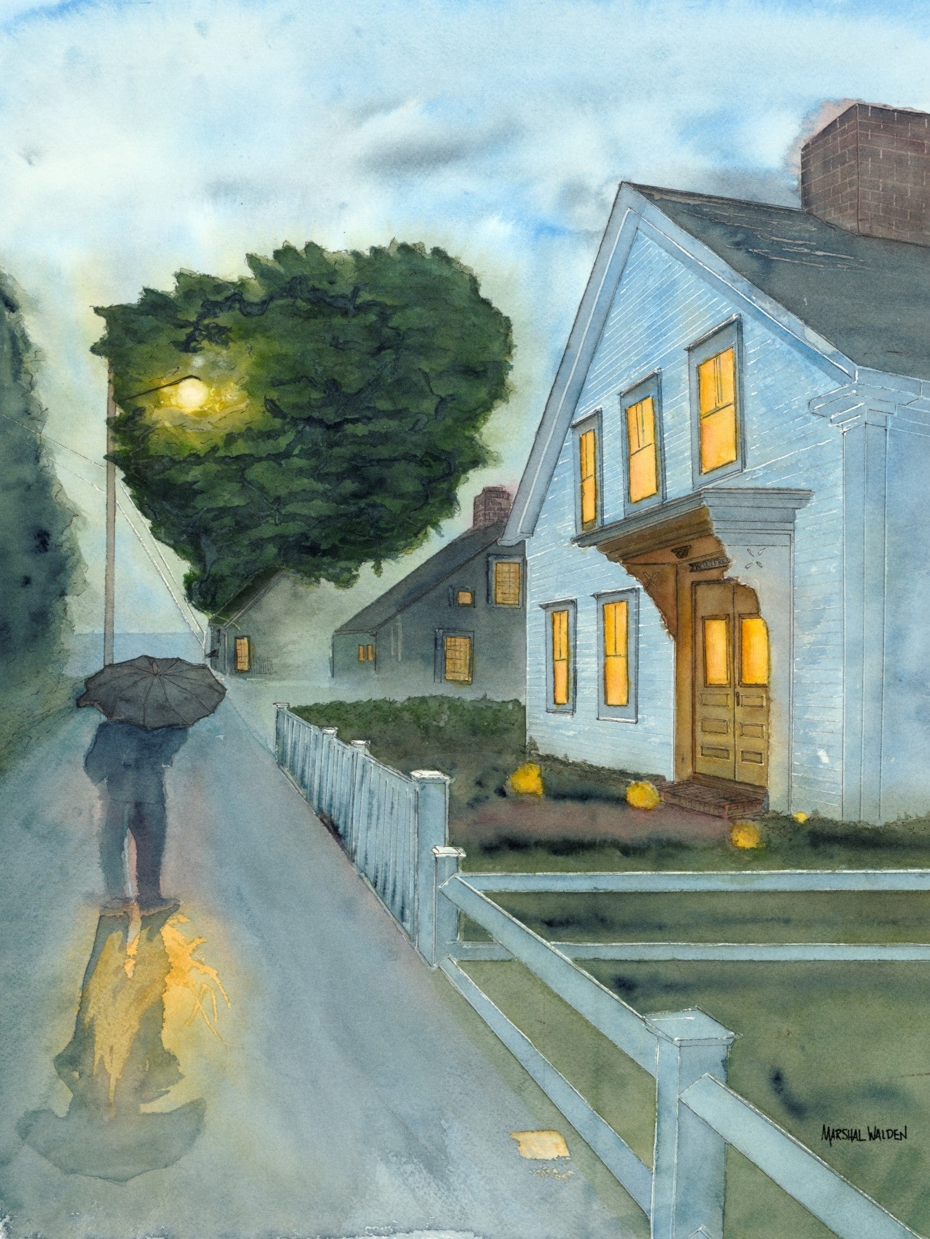A detailed close-up photograph showing the textured surface of a fine art print of the "Stroll In Rain" watercolor painting by PAAM member artist Marshal Walden. The image reveals the grain of the archival paper and the intricate details of the glistening wet pavement reflections, the figure under an umbrella, and the warm light glowing from the white two-story home windows.
