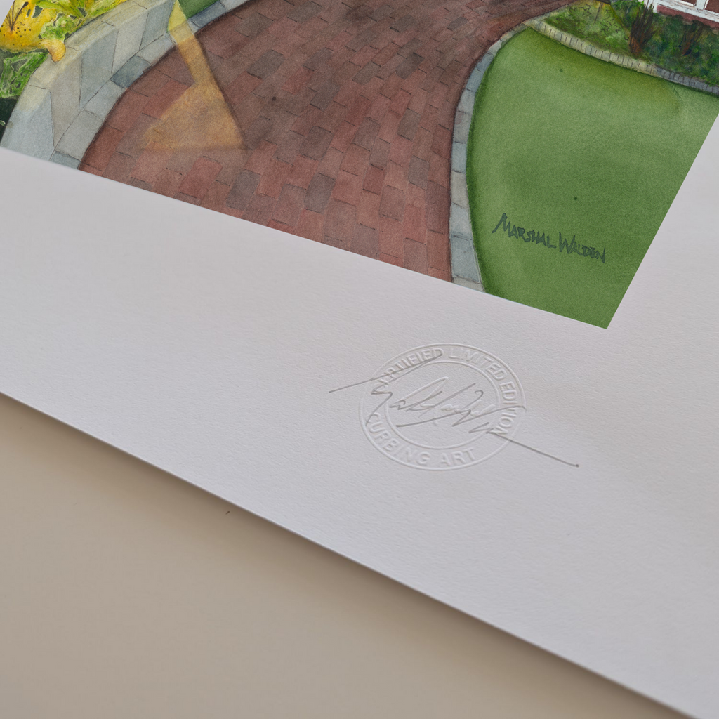 A macro photograph showing the lower corner details of the limited edition fine art print "Red Inn Summer Glow." The focus is on PAAM member artist Marshal Walden's signature written in graphite pencil next to the raised, circular official "Curbing Art" studio embossing seal pressed into the surface. The lighting and close perspective emphasize the deep texture, tooth, and substantial thickness of the heavy archival paper stock edges.

