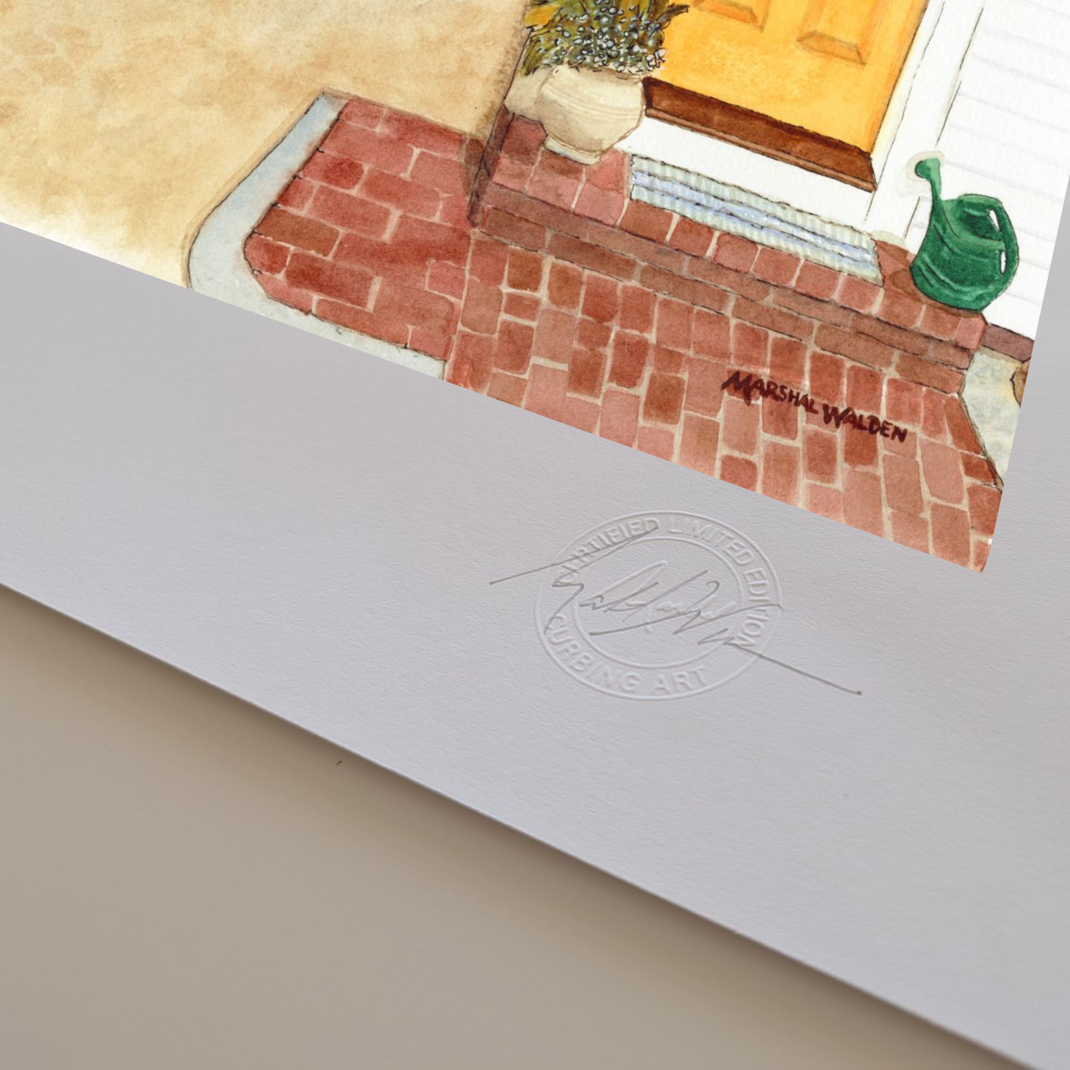 A macro photograph of the bottom corner of the limited edition fine art print "The Turn - Yellow Door." The image highlights the textured surface and visible thickness of the heavyweight archival paper stock. Visible on the white border are the raised, circular Curbing Art Certified Limited Edition embossed seal and artist Marshal Walden's hand-signed signature in graphite pencil.
